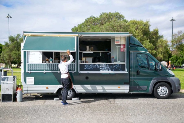 a man lifting a food truck window