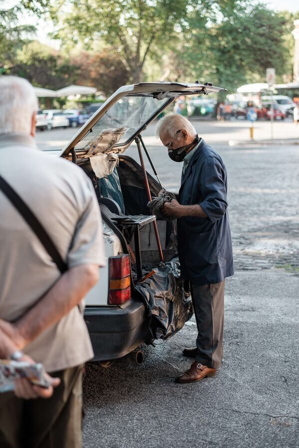 An older man fixing his broken hatch lift supports
