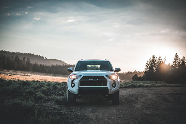 white Toyota parked in the mountains